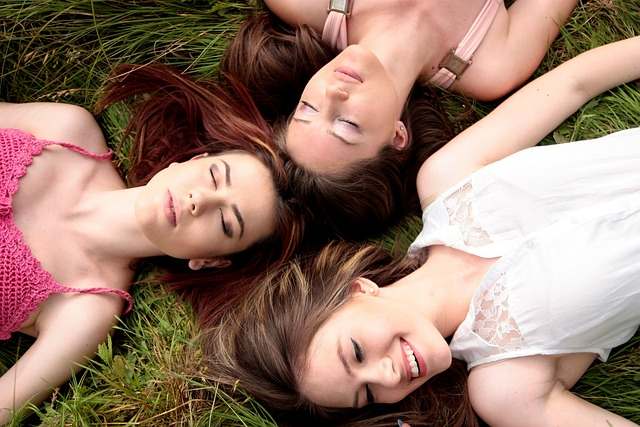3 femmes couchées dans l'herbe